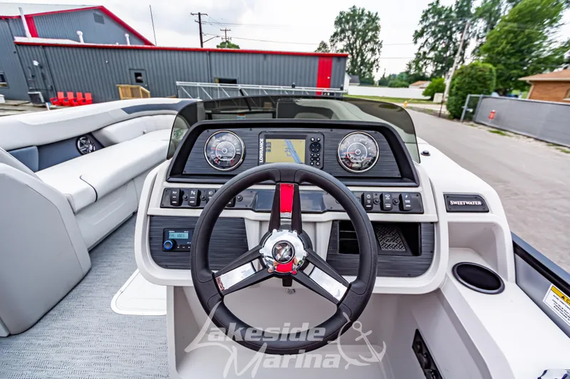 Slide: The Image of 2026 Godfrey Sweetwater 2286 SBC boat dashboard with steering wheel and navigation controls. - 14
