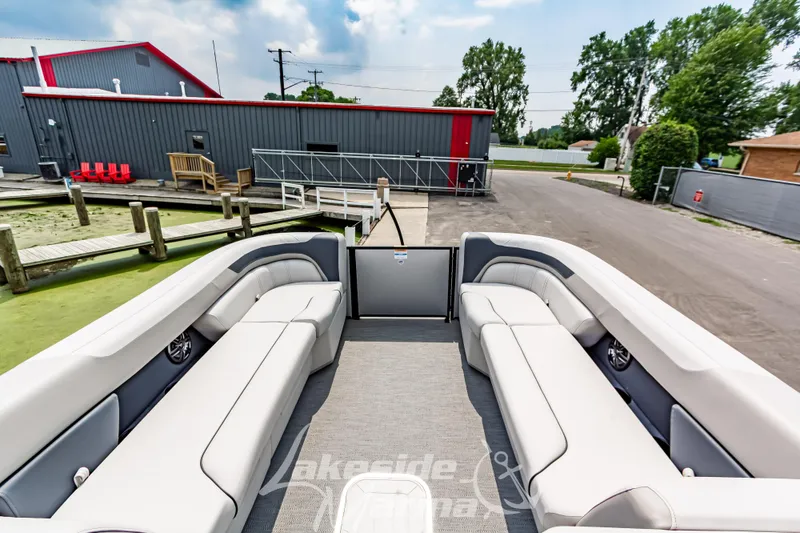 Slide: The Image of 2026 Godfrey Sweetwater 2286 SBC pontoon boat with spacious seating at a dock. - 25