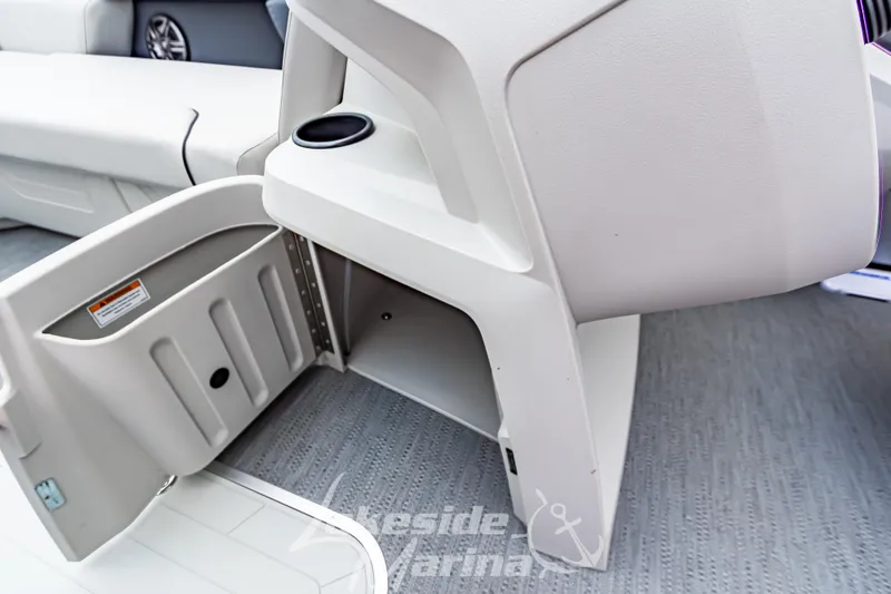 Slide: The Image of 2026 Godfrey Sweetwater 2286 SBC boat interior with storage compartment and cup holder. - 7
