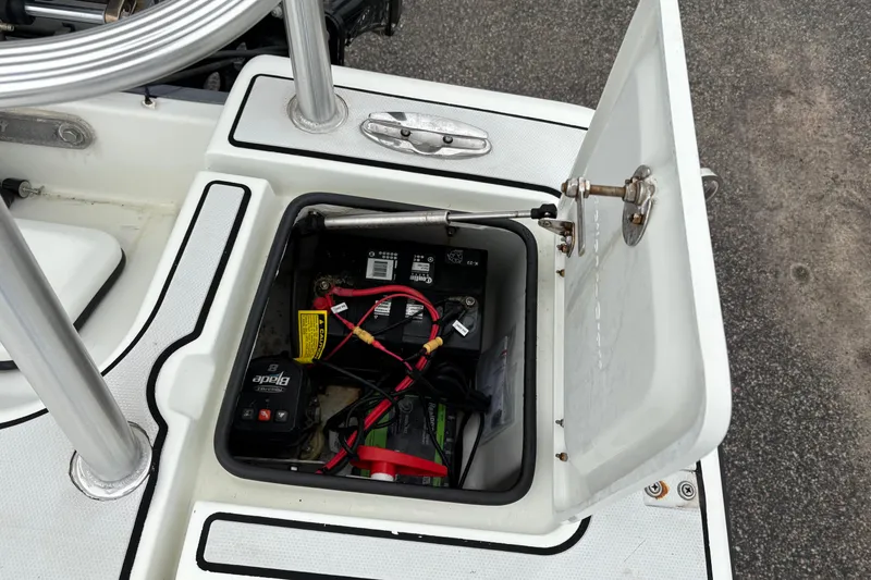 Slide: The Image of Open battery compartment of 2017 Action Craft Flatsmaster 1820 boat, showing wiring and components. - 10