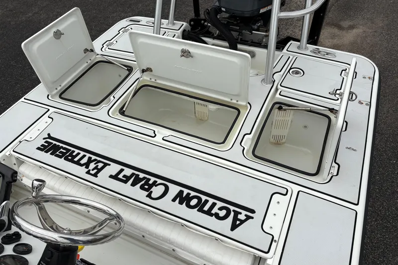 Slide: The Image of 2017 Action Craft Flatsmaster 1820 boat deck with open storage compartments. - 12