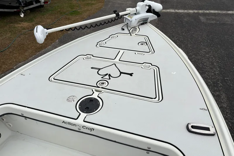 Slide: The Image of 2017 Action Craft Flatsmaster 1820 boat deck with trolling motor and storage compartments. - 19