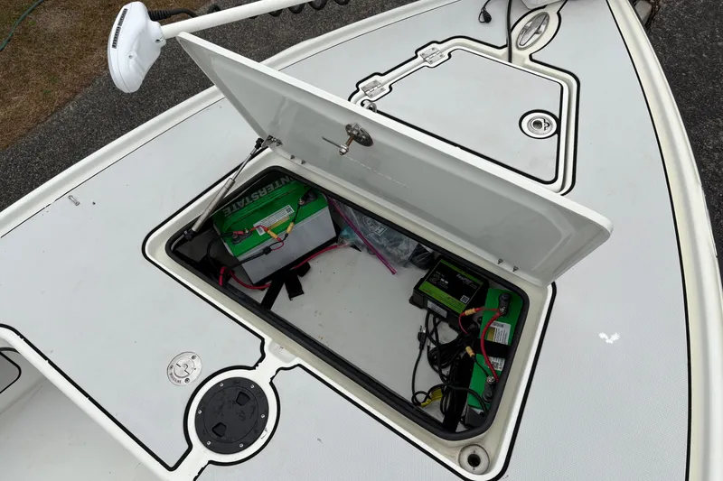 Slide: The Image of 2017 Action Craft Flatsmaster 1820 boat with open storage compartment showing battery and wiring. - 20