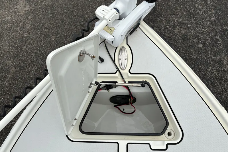 Slide: The Image of 2017 Action Craft Flatsmaster 1820 boat hatch open, revealing interior storage. - 21