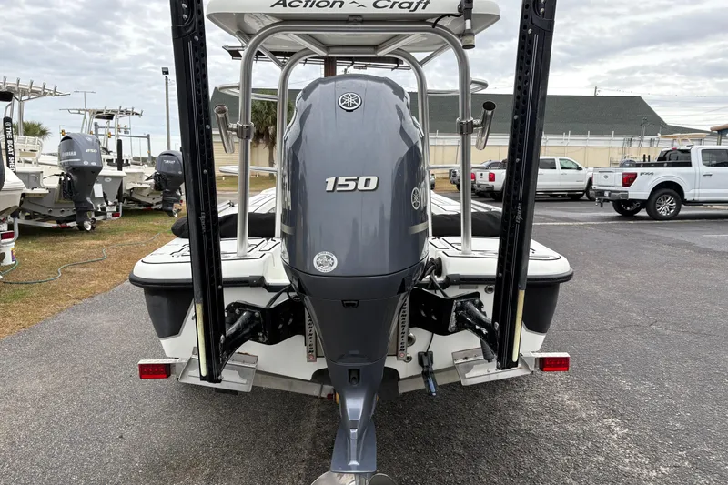 Slide: The Image of 2017 Action Craft Flatsmaster 1820 boat with Yamaha 150 outboard motor, parked outdoors. - 3