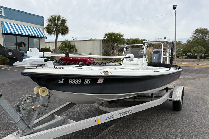 Slide: The Image of 2017 Action Craft Flatsmaster 1820 boat on trailer in parking lot. - 8