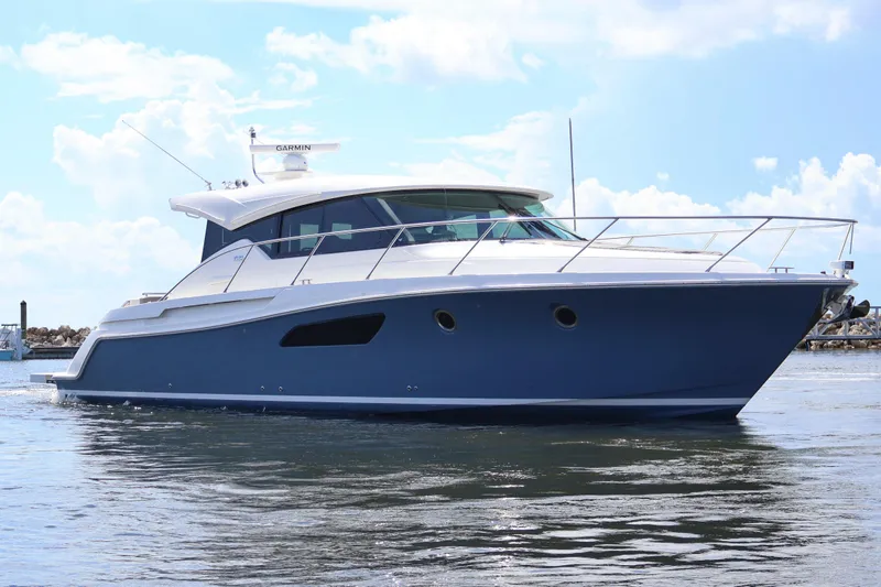 Slide: The Image of 2020 Tiara Yachts C44 Coupe cruising on calm waters under a clear sky. - 0