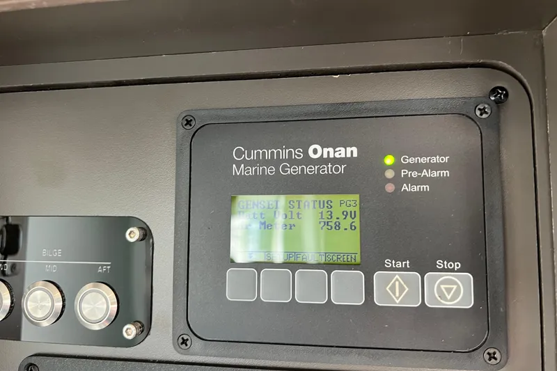 Slide: The Image of Control panel of Cummins Onan marine generator on 2020 Tiara Yachts C44 Coupe. - 104