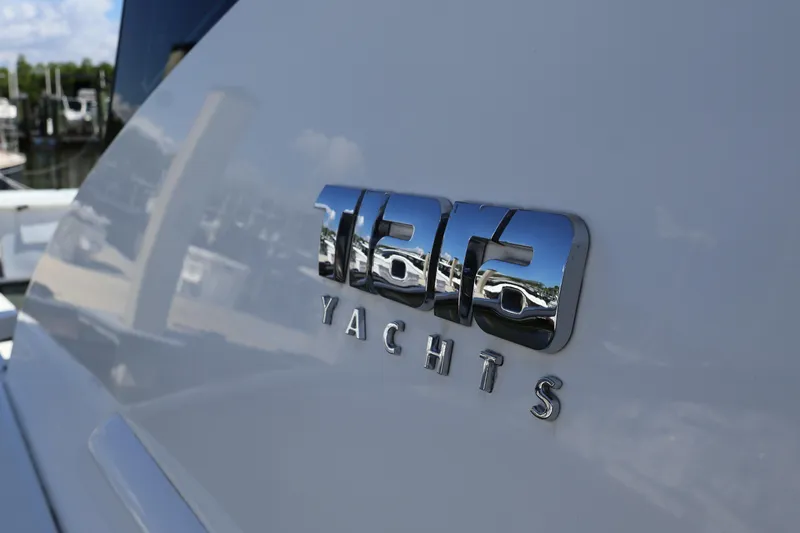 Slide: The Image of Tiara Yachts logo on 2020 C44 Coupe, reflecting marina scenery. - 14