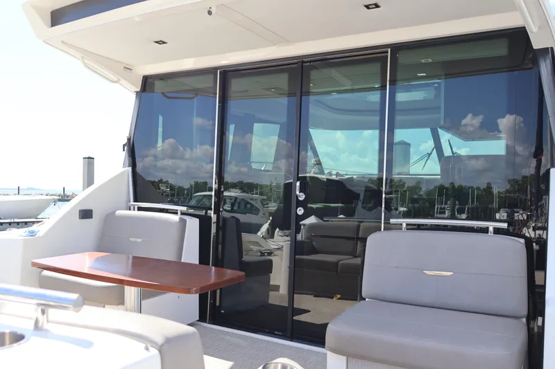 Slide: The Image of 2020 Tiara Yachts C44 Coupe with sleek glass doors and comfortable seating area. - 15