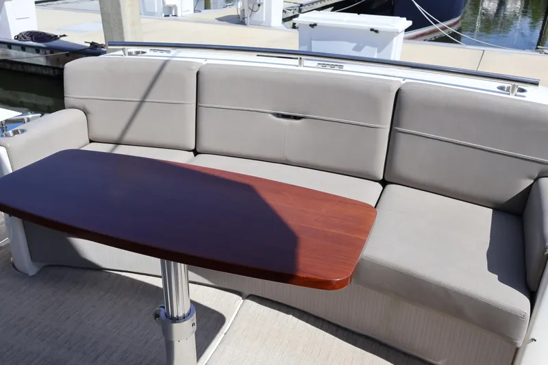 Slide: The Image of 2020 Tiara Yachts C44 Coupe interior with gray seating and wooden table. - 20