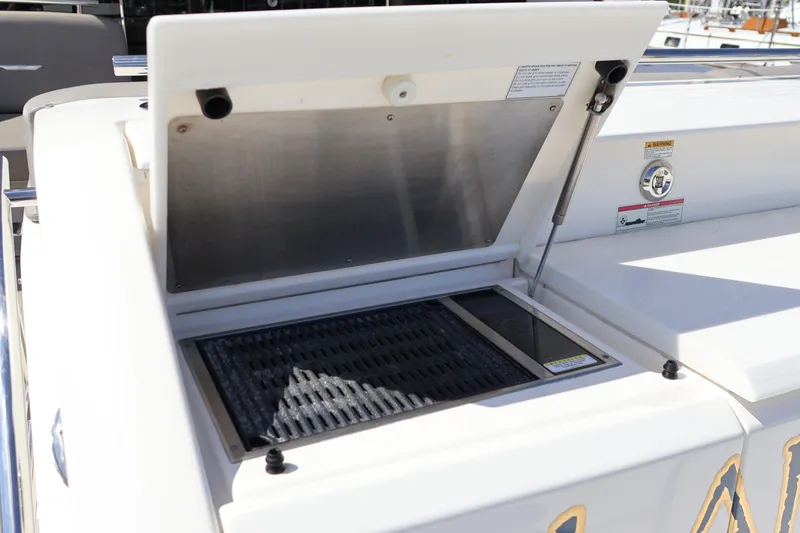 Slide: The Image of Outdoor grill on 2020 Tiara Yachts C44 Coupe, open lid, stainless steel finish. - 25