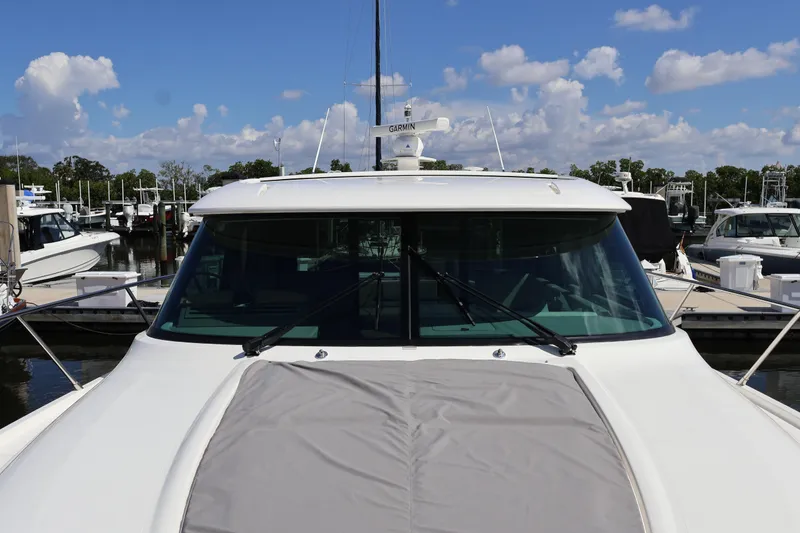 Slide: The Image of 2020 Tiara Yachts C44 Coupe docked at marina under blue sky. - 28