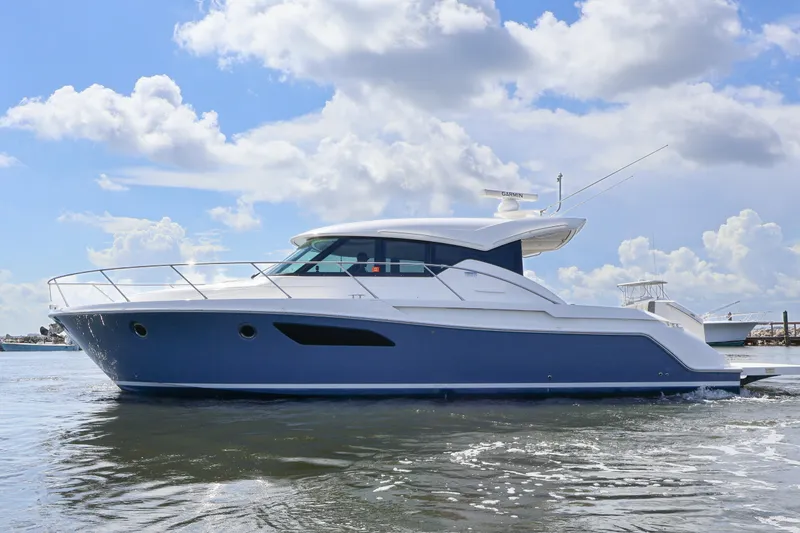 Slide: The Image of 2020 Tiara Yachts C44 Coupe cruising on a sunny day with blue skies. - 3