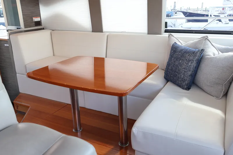 Slide: The Image of 2020 Tiara Yachts C44 Coupe interior with elegant seating and wooden table. - 33