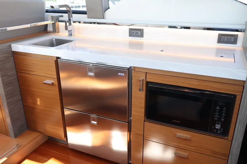 Slide: The Image of Modern kitchen area in 2020 Tiara Yachts C44 Coupe with stainless steel appliances. - 44