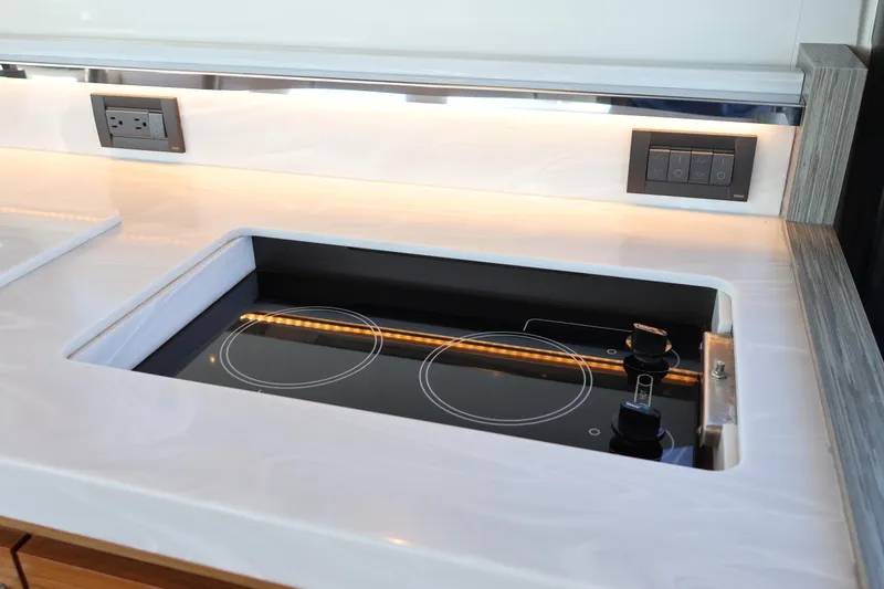 Slide: The Image of Modern kitchen stove on 2020 Tiara Yachts C44 Coupe, featuring sleek design and integrated controls. - 49