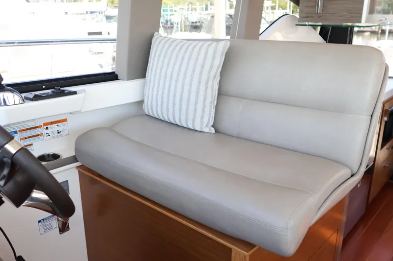 Slide: The Image of Luxurious seating area inside 2020 Tiara Yachts C44 Coupe with striped cushion. - 58