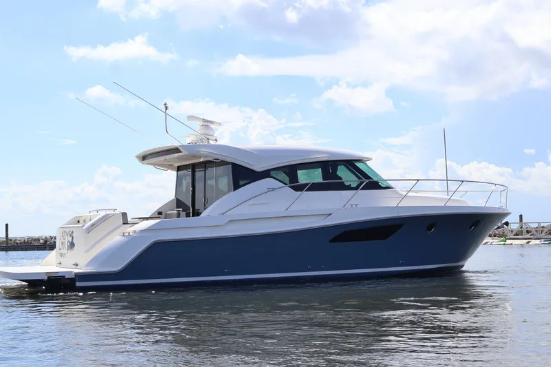 Slide: The Image of 2020 Tiara Yachts C44 Coupe on water, sleek design, blue and white exterior. - 6