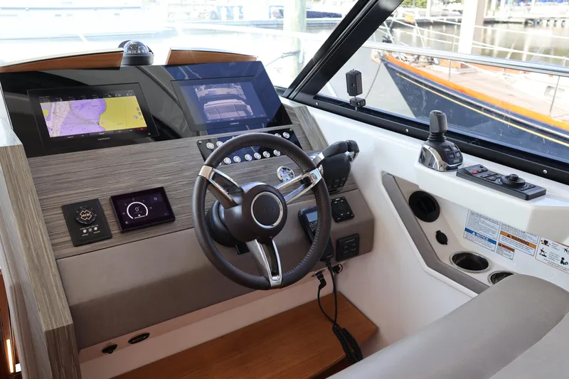 Slide: The Image of 2020 Tiara Yachts C44 Coupe helm with advanced navigation displays and controls. - 60