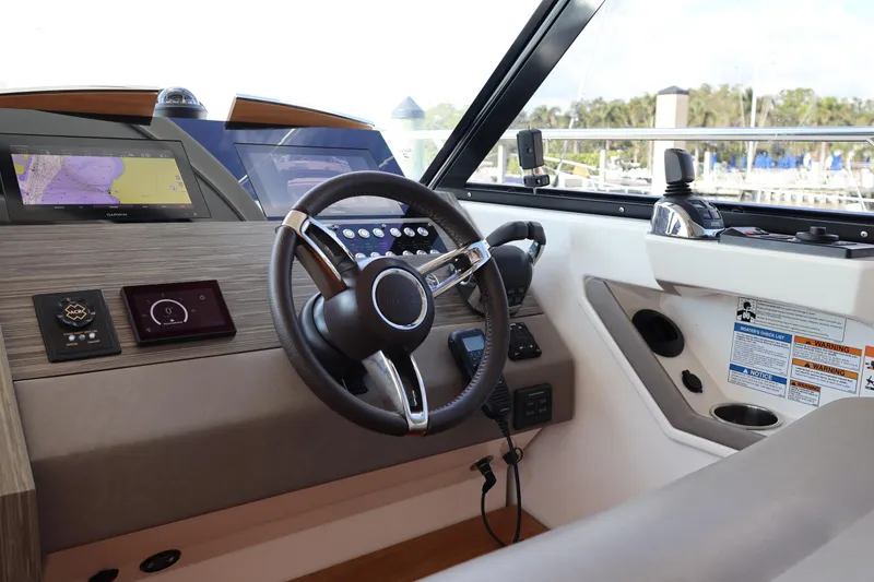 Slide: The Image of 2020 Tiara Yachts C44 Coupe helm with advanced navigation displays and controls. - 61