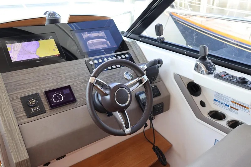 Slide: The Image of 2020 Tiara Yachts C44 Coupe helm with advanced navigation and control systems. - 62