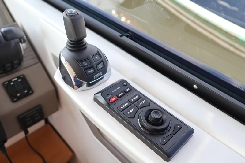 Slide: The Image of Control panel of 2020 Tiara Yachts C44 Coupe with joystick and navigation controls. - 66
