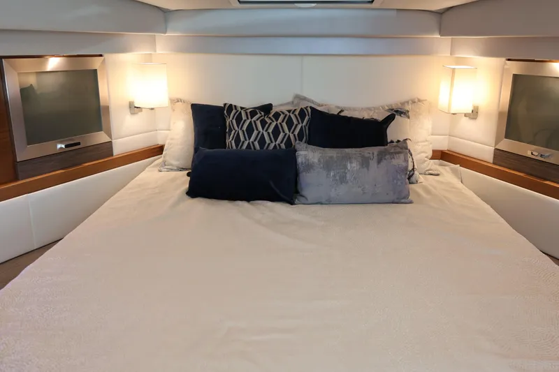 Slide: The Image of Luxurious bedroom interior of 2020 Tiara Yachts C44 Coupe with elegant bedding and lighting. - 72
