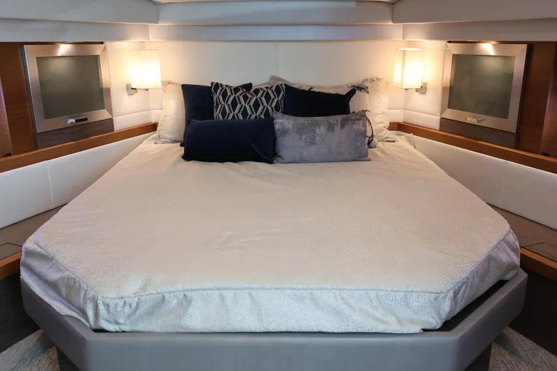 Slide: The Image of Luxurious bedroom interior of 2020 Tiara Yachts C44 Coupe with elegant bedding and ambient lighting. - 73