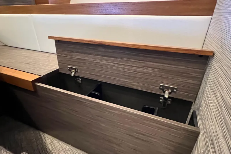 Slide: The Image of 2020 Tiara Yachts C44 Coupe interior storage compartment with wood finish. - 81