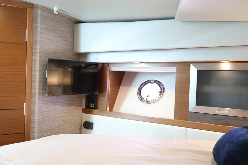 Slide: The Image of Interior of 2020 Tiara Yachts C44 Coupe with TV and porthole window. - 83