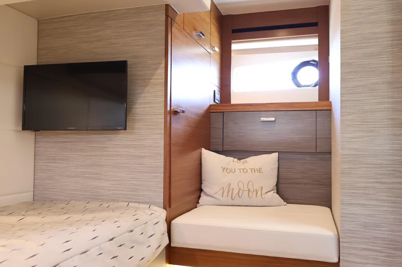 Slide: The Image of 2020 Tiara Yachts C44 Coupe interior with TV, cushion, and modern decor. - 91