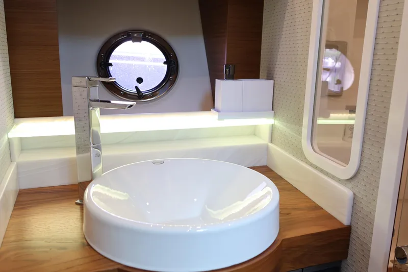 Slide: The Image of Modern bathroom interior of 2020 Tiara Yachts C44 Coupe with round sink and porthole window. - 95