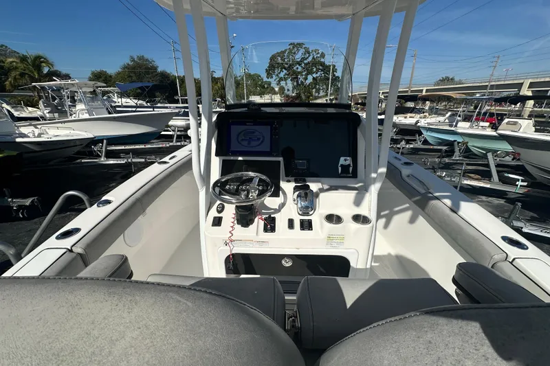 Slide: The Image of 2020 Sea Pro 239 Center Console boat interior with steering wheel and controls. - 16