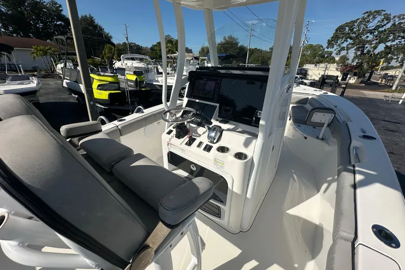 Slide: The Image of 2020 Sea Pro 239 Center Console boat interior with steering wheel and seating. - 17