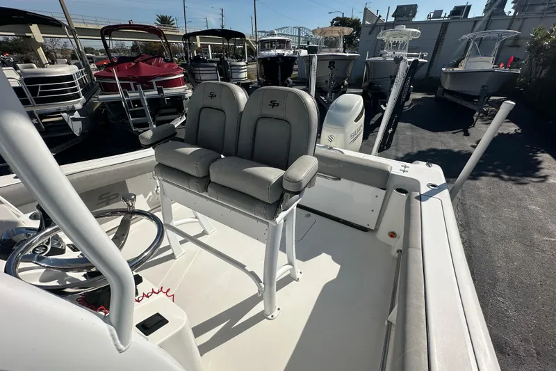 Slide: The Image of 2020 Sea Pro 239 Center Console boat interior with dual seating and steering wheel. - 19
