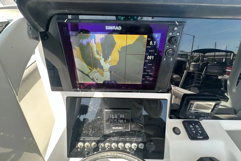Slide: The Image of 2020 Sea Pro 239 Center Console dashboard with Simrad navigation display. - 23