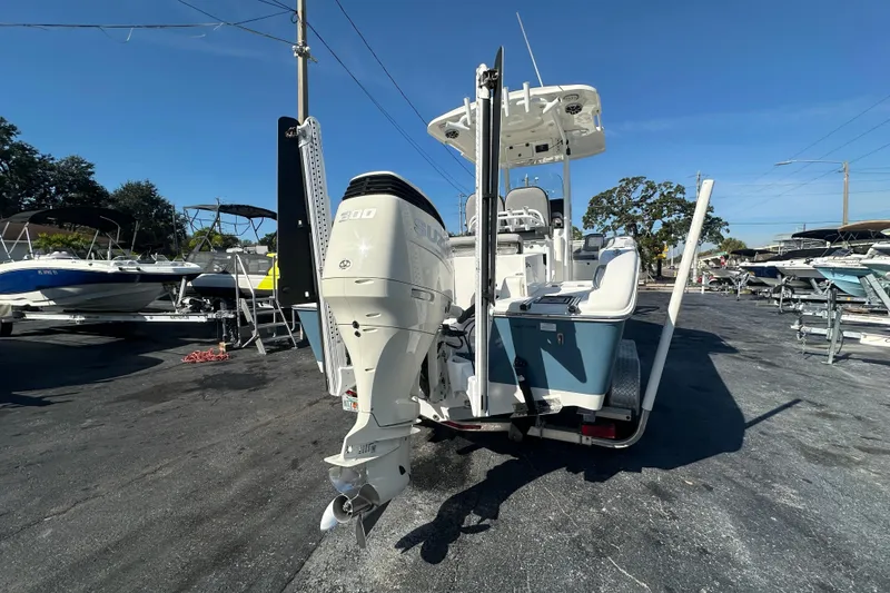 Slide: The Image of 2020 Sea Pro 239 Center Console boat with Suzuki outboard motor in a marina setting. - 4