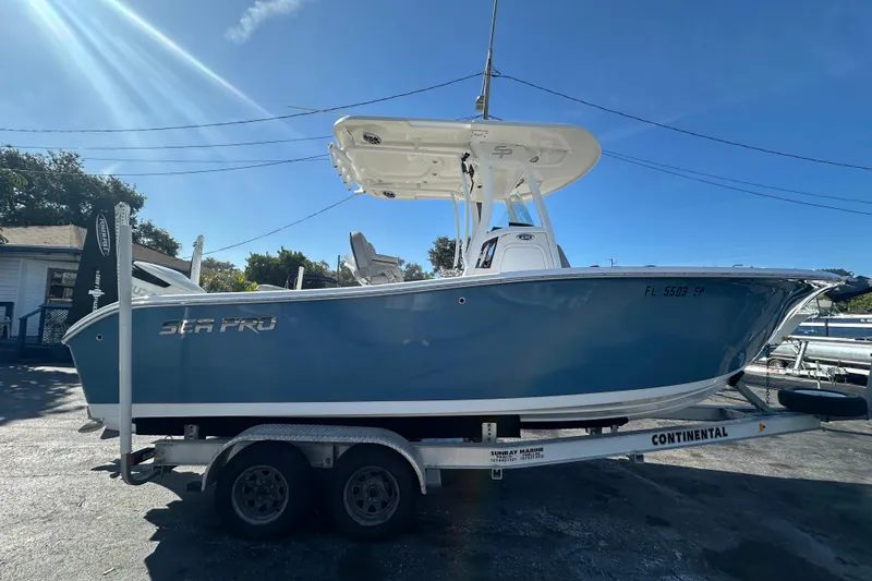 Slide: The Image of 2020 Sea Pro 239 Center Console boat on trailer under clear blue sky. - 6