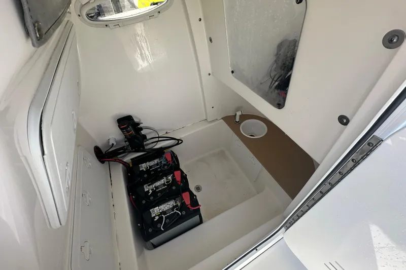 Slide: The Image of Interior of 2020 Sea Pro 239 Center Console boat showing battery compartment and storage. - 8