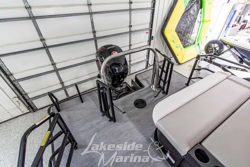 Slide: The Image of 2026 Godfrey Sweetwater 2286 SFLX boat interior with motor, in a marina setting. - 32