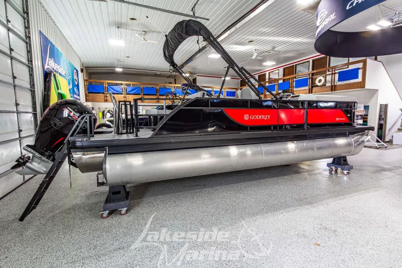 Slide: The Image of 2026 Godfrey Sweetwater 2286 SFLX pontoon boat in showroom, featuring sleek design and modern amenities. - 5