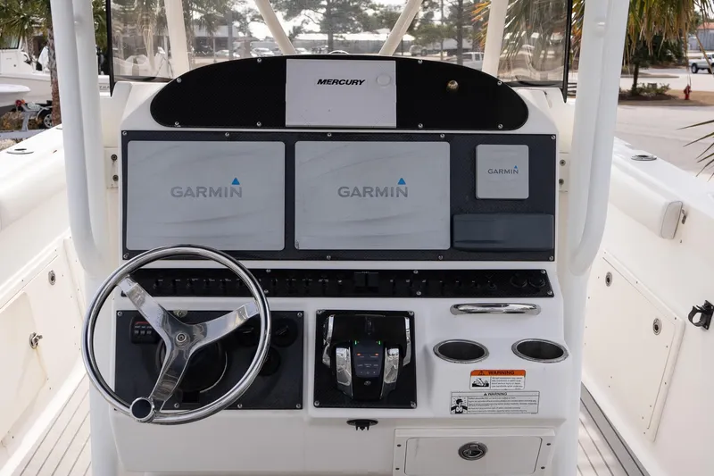 Slide: The Image of 2007 Wellcraft 35 Tournament boat interior with triple Mercury engines, parked near dealership. - 12