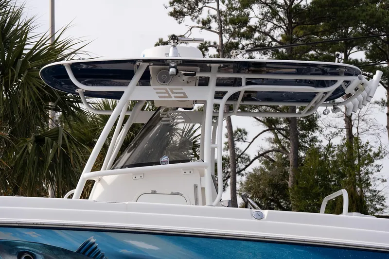 Slide: The Image of 2007 Wellcraft 35 Tournament boat's T-top structure in a marina setting. - 19