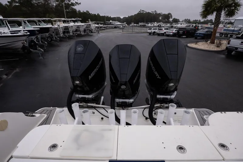 Slide: The Image of 2007 Wellcraft 35 Tournament boat with triple Mercury outboard engines in a marina. - 21