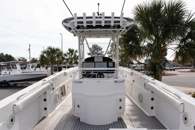 Slide: The Image of 2007 Wellcraft 35 Tournament boat, spacious deck, palm trees in background, overcast sky. - 7