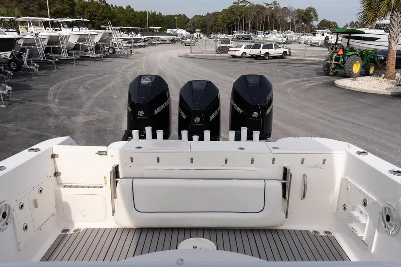 Slide: The Image of 2007 Wellcraft 35 Tournament boat with triple Mercury engines, docked in a marina. - 8