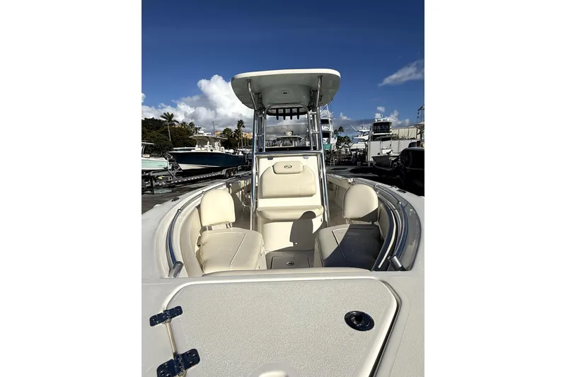 Slide: The Image of 2021 Key West 239 FS boat with seating, under a clear blue sky. - 10