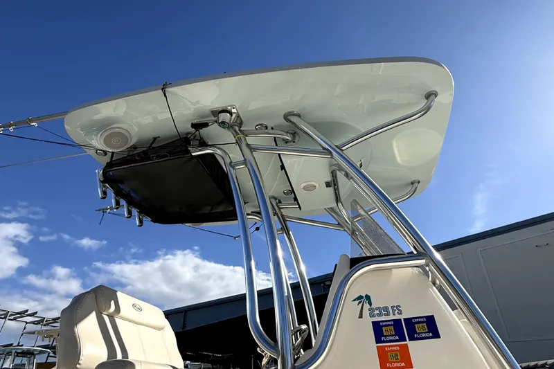 Slide: The Image of 2021 Key West 239 FS boat with T-top and seating, under clear blue sky. - 11