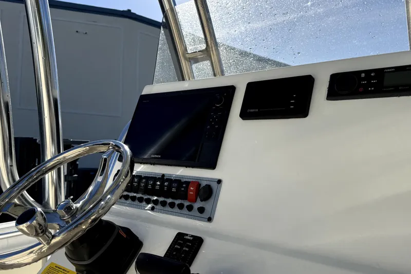 Slide: The Image of 2021 Key West 239 FS boat dashboard with steering wheel and electronic controls. - 12
